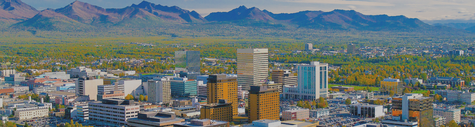 Anchorage skyline, with Chugach Range in the background and the iconic Captain Cook Hotel in the foreground