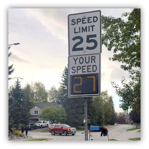 A speed limit sign showing 25 with a speed checker showing Your Speed 27